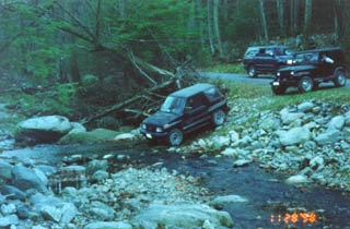 The Suzuki fords the stream.